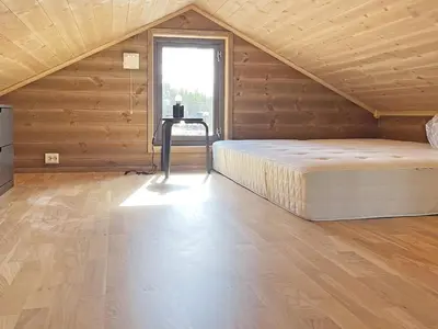 a large bedroom with a bed and a window at 6 person holiday home in Sollia-By Traum in Brenn