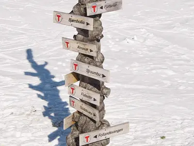 a directional sign in the snow with a shadow at 6 person holiday home in Sollia-By Traum in Brenn