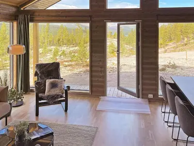 a living room with a chair and large windows at 6 person holiday home in Sollia-By Traum in Brenn