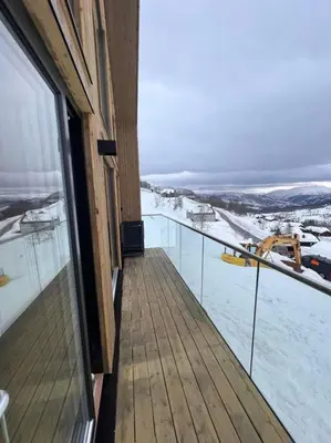 a balcony of a building with snow on the ground at Rindabotn Fjelltun ski in-ski out in Sogndal