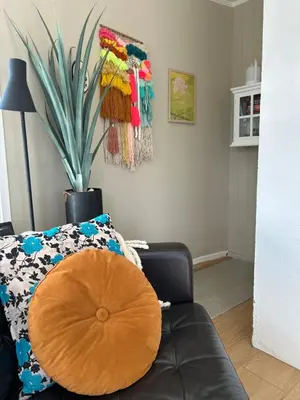 a room with a black couch with a wooden circle on it at Sveggvika Atlantic Home in Averoy