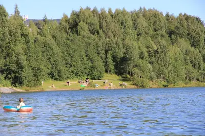 a woman in a kayak in the middle of a lake at Lillehammer Turistsenter Camping in Lillehammer