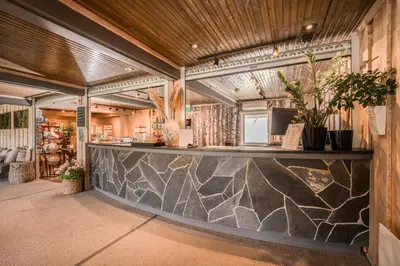 a bar in a building with a stone wall at Lillehammer Turistsenter Camping in Lillehammer