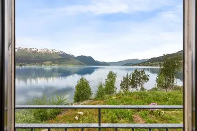 a view of a lake from a window at Modern house by the Fjord in Sandane, Nordfjord. in Sandane