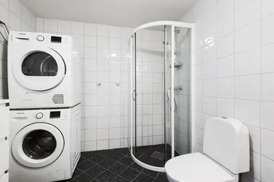 a bathroom with a washing machine and a toilet at Modern and central apartment in Bergen in Bergen