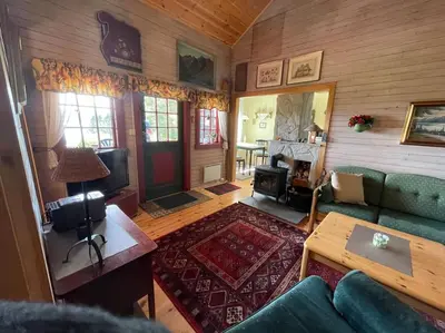 an overhead view of a living room with a couch and a table at Sjarmerende hytte omgitt av vakker natur in Molde