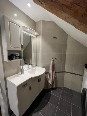 a bathroom with a sink and a mirror at Central Two Room Apartment! in Trondheim