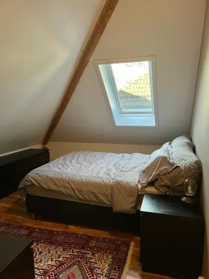 a bedroom with a bed and a window at Central Two Room Apartment! in Trondheim