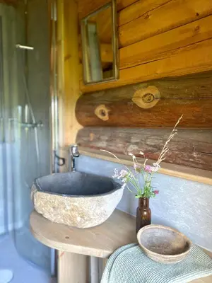 a bathroom with a stone sink on a table at Kufjøset in Skjåk