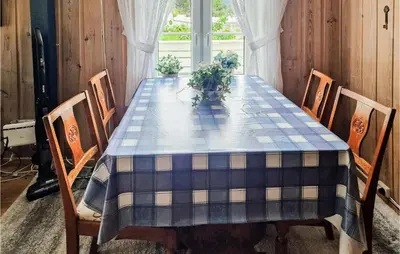 a dining room table with a blue checkered table cloth at 4 Bedroom Stunning Home In Fjæra in Fjæra
