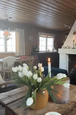 a vase filled with white flowers on a table at Cozy family friendly cabin at beautiful location! in Geilo