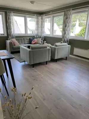 a living room with two couches and a table at Leilighet i Odda sentrum in Odda