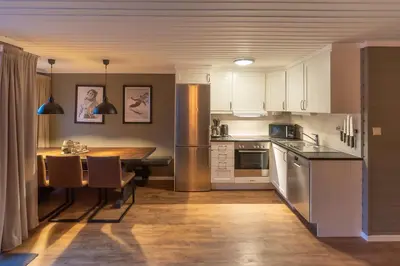 a kitchen with a table and a dining room at Trysil Alpin 40A in Trysil