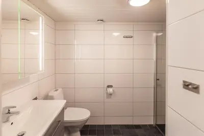 a bathroom with a toilet and a sink and a shower at Trysil Alpin 40A in Trysil