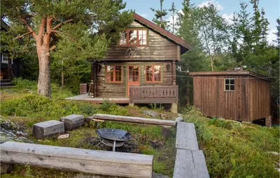 a log cabin with a grill in front of it at 3 Bedroom Stunning Home In Rjukan in Gaustablikk