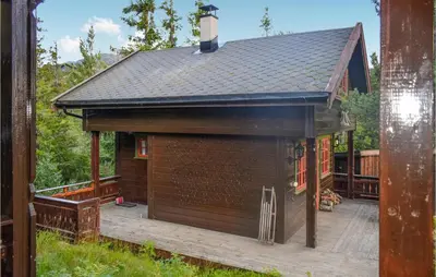 a large brown building with a deck and a roof at 3 Bedroom Stunning Home In Rjukan in Gaustablikk