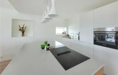 a white kitchen with a large white counter top at 3 Bedroom Lovely Home In Stolmen