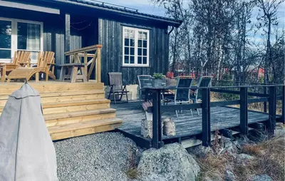 a cabin with a table and chairs on a deck at 3 Bedroom Nice Home In Gol in Gol