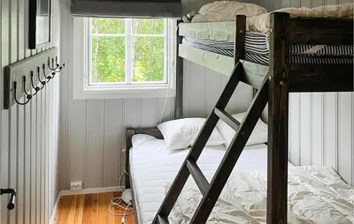 a bedroom with two bunk beds and a window at 3 Bedroom Nice Home In Gol in Gol