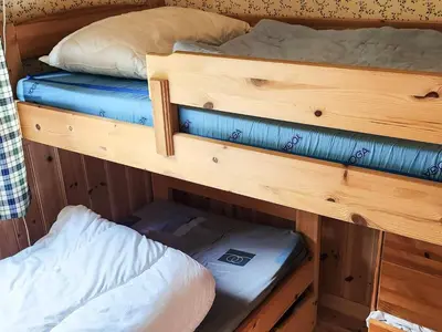two bunk beds in a room with a mattress at 9 person holiday home in MOSTERHAMN-By Traum in Mosterhamn
