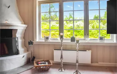 a living room with a fireplace and a window at 4 Bedroom Nice Home In Hemsedal in Hemsedal