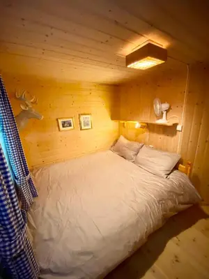 a bedroom with a bed in a log cabin at Three bedroom holiday house with jacuzzi in Bjorli , pets allowed in Bjorli