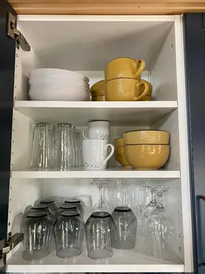 a cabinet filled with glasses and plates and bowls at Three bedroom holiday house with jacuzzi in Bjorli , pets allowed in Bjorli