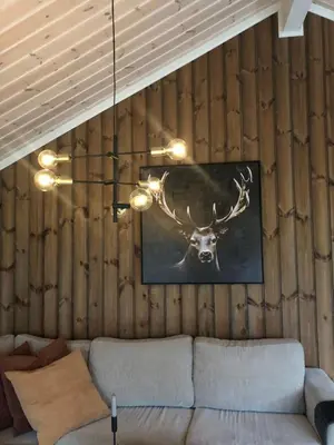a painting of a deer on the wall of a living room at Storekleiv Hyttefelt Tuddal in Tuddal