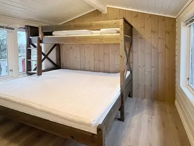 a room with two bunk beds in a cabin at 6 person holiday home in bremnes-By Traum in Bremnes