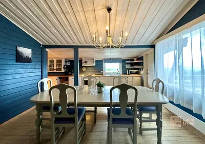 a dining room with a table and four chairs at Large cabin Sjusjøen XC ski in out & lovely view in Ringsaker
