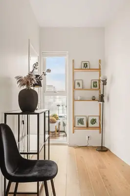 a room with a chair and a table and a window at Dinbnb Apartments I Luxury with Views l Large Balcony in Bergen