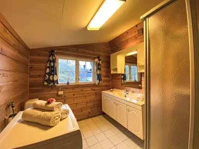 a bathroom with a tub and a sink and a shower at Chalet Krampehaugen by Interhome in Utvik