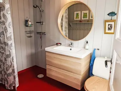 a bathroom with a sink and a mirror at Holiday Home Ørviksnes by Interhome in Steinstø