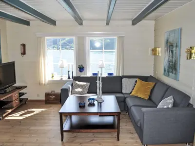 a living room with a couch and a coffee table at Holiday Home Ørviksnes by Interhome in Steinstø
