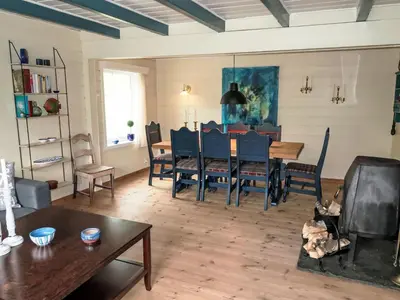 a living room with a dining room table and chairs at Holiday Home Ørviksnes by Interhome in Steinstø