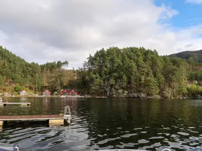 a dock in the middle of a lake at Apartment Heningen by Interhome in Uggdal