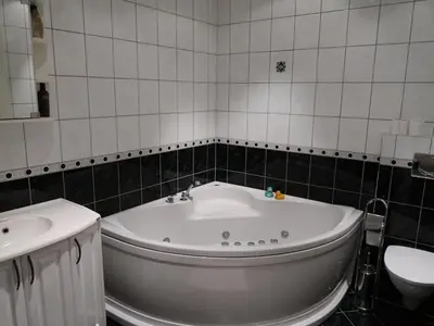 a bathroom with a white tub and a sink at Apartment Heningen by Interhome in Uggdal