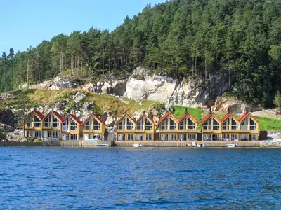 a row of houses on the shore of a body of water at Apartment Heningen by Interhome in Uggdal