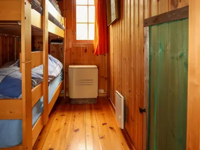 a room with two bunk beds and a window at Chalet Trefall by Interhome in Gausvik