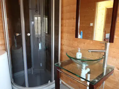 a bathroom with a glass sink and a shower at Holiday Home Sjøhytta by Interhome in Bekkjarvik