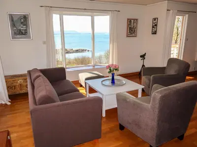 a living room with two chairs and a table at Holiday Home Villa Hjartnes by Interhome in Hjartåker