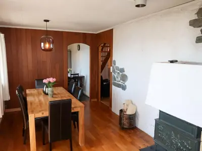 a dining room with a wooden table and chairs at Holiday Home Villa Hjartnes by Interhome in Hjartåker