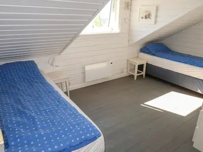 a small room with two beds and a window at Holiday Home Villa Hjartnes by Interhome in Hjartåker
