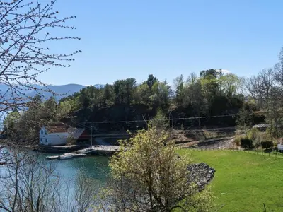 a view of a river with a house and trees at Holiday Home Villa Hjartnes by Interhome in Hjartåker