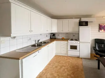 a kitchen with white cabinets and a sink and a refrigerator at Apartment Bakkafall by Interhome in Svortevik