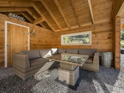 a living room with a table and chairs in a cabin at Holiday Home Kaja by Interhome in Vik