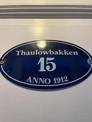 a blue sign with the number on it at Bo i historisk bygning, kort vei til sentrum in Trondheim