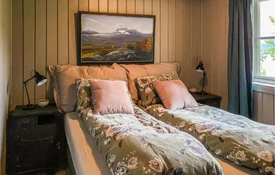 a living room with a couch with pillows on it at Nice Home In Sykkylven With Kitchen in Sykkylven