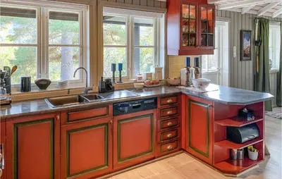 a kitchen with a sink and a counter top at Nice Home In Sykkylven With Kitchen in Sykkylven