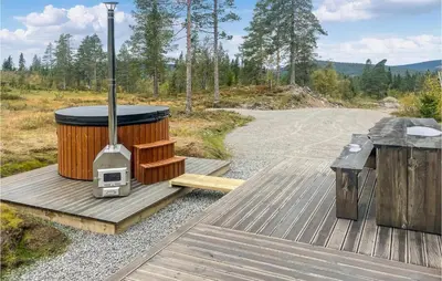 a wood stove on a deck next to a road at Pet Friendly Home In Trysil With Wifi in Trysil